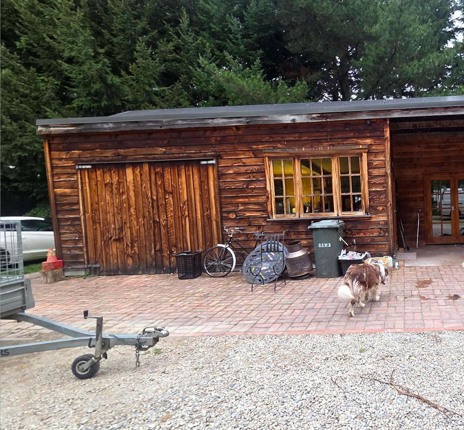 Decluttering · interior & exterior Styling · Property Staging Weathered wooden barn or garage exterior with bikes parked outside on a brick driveway